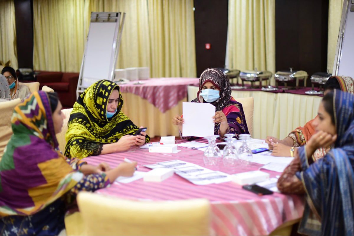 women around a table working