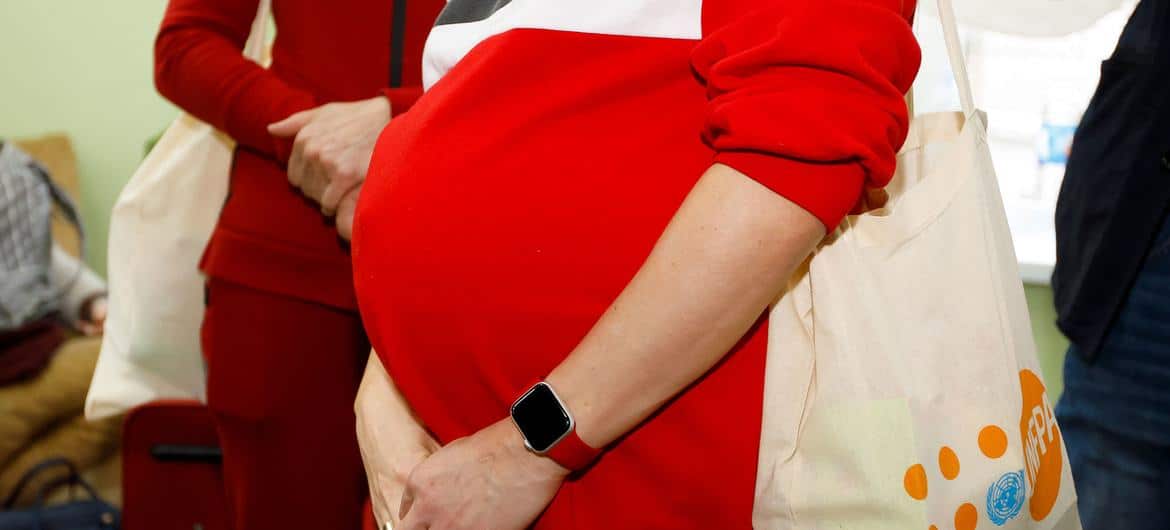 A heavily pregnant Ukranian woman who left Odessa with her mother and young son receives a dignity kit at a placement centre in Moldova's capital city, Chișinău. 