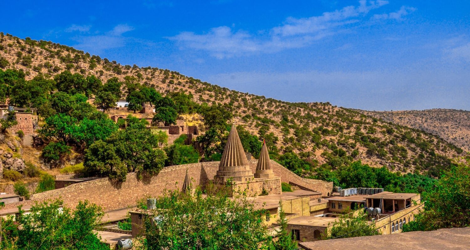 Lalish - brown concrete building on top of mountain during daytime